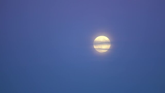 Full moon during a blue dusk.