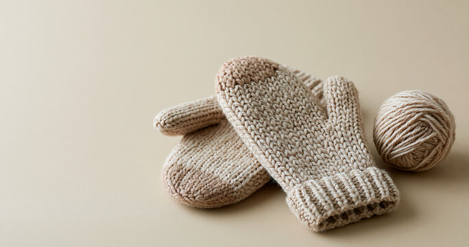 Handmade knitted mittens with yarn ball