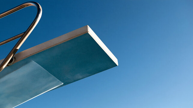 View of a diving board against a blue sky, sport concept, public plunge pool setting, with copy space