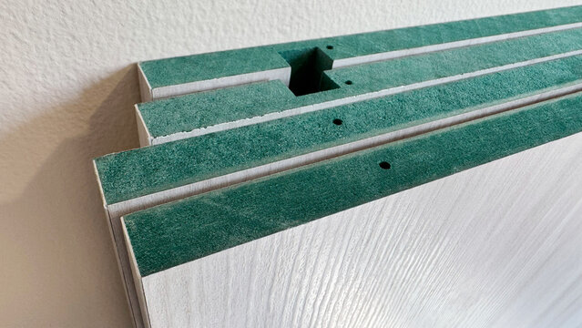 Stack of HMR (High Moisture Resistance) boards with melamine wood grain texture surface