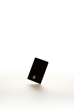 Blank Black Credit Card Floating on Minimalist White Background