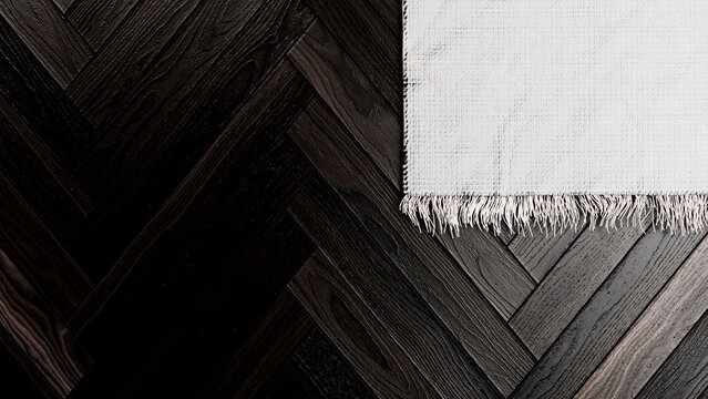 White textured woven rug with fringe on dark wood parquet floor