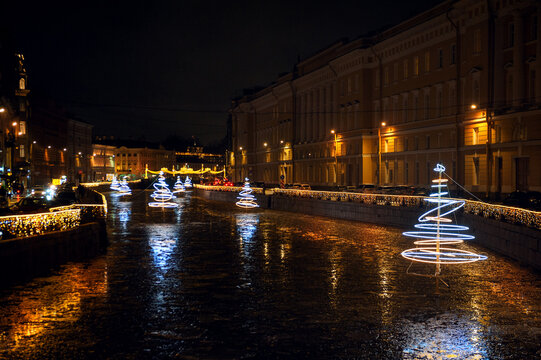 Christmas city lights illuminate a historic canal