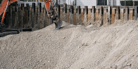 Excavator digging a foundation pit at an urban construction site, heavy machiner © Natalia Schuchardt