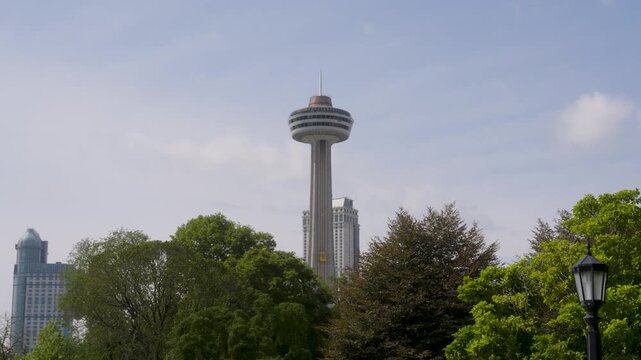 Skylon Tower Rising Above Green Trees in Niagara Falls