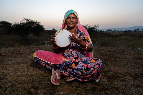 Rajasthani folklore musician with Khanjari Dafli instrument in Pushkar Rajasthan India