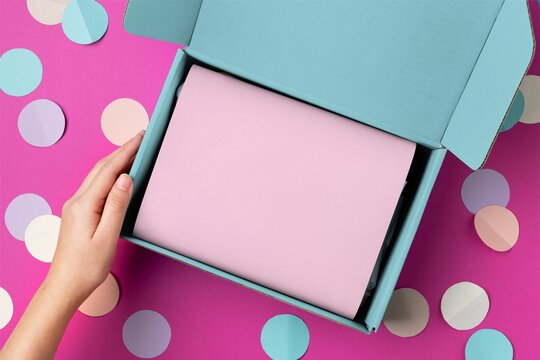 Pastel gift box with pink card on confetti background