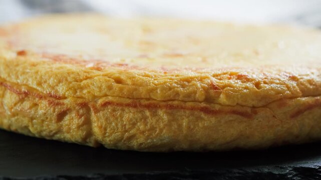 Close up of Spanish tortilla de patatas, a thick omelet made with eggs, potatoes and onions fried in olive oil, served as a traditional Spanish tapas dish.