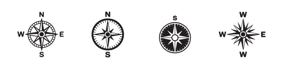 Collection of four diverse compass icons and wind rose emblems for directional guidance and travel themes. © Joynab