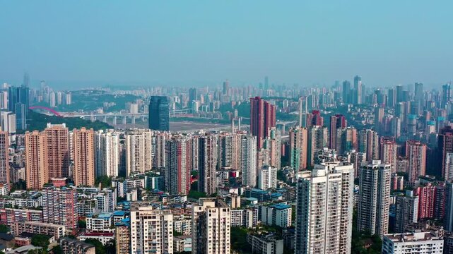 Aerial view of dense city skyline with high-rise buildings and river in Chongqing, China