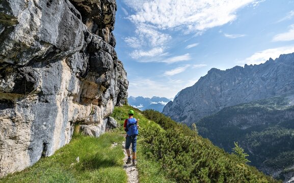 Young hiker, mountaineer on the Sentiero Carlo Minazio path, view of the Valle di San Vito, Sorapiss circuit, Dolomites, Belluno, Italy