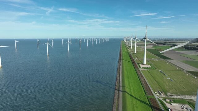 An aerial tour of Windpark Noordoostpolder, recorded from above the waters of the IJsselmeer in Flevoland, The Netherlands.