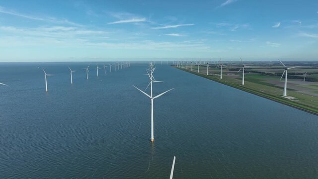 An aerial tour of Windpark Noordoostpolder, recorded from above the waters of the IJsselmeer in Flevoland, The Netherlands.