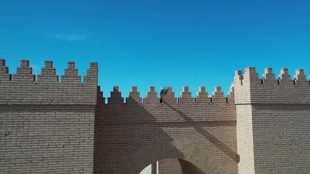 Low drone shot of the reconstructed walls and gate of ancient Babylon, Iraq
