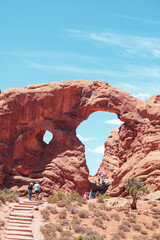 Hikers walking toward Turret Arch in Arches National Park, Utah © Anna