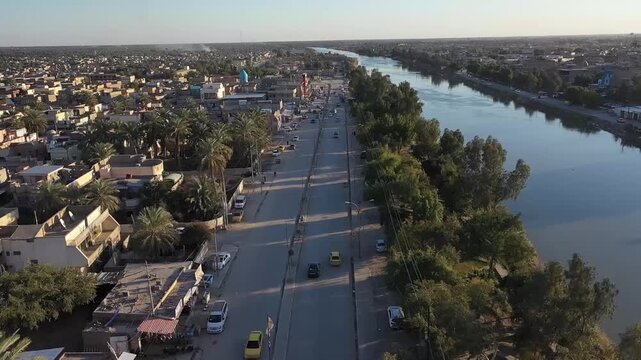 High-angle aerial view of the city of Hilla along the Shatt al-Hilla river, Iraq
