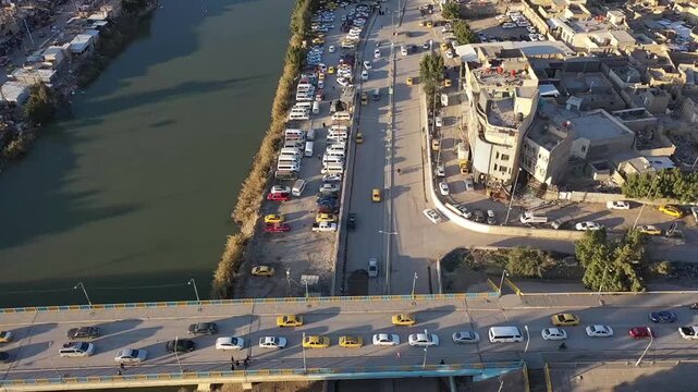 Cinematic drone footage of the city of Hilla along the Shatt al-Hilla river, Iraq