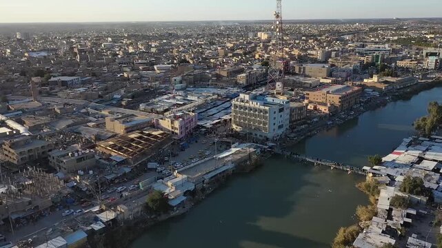 Wide aerial shot of the city of Hilla along the Shatt al-Hilla river, Iraq