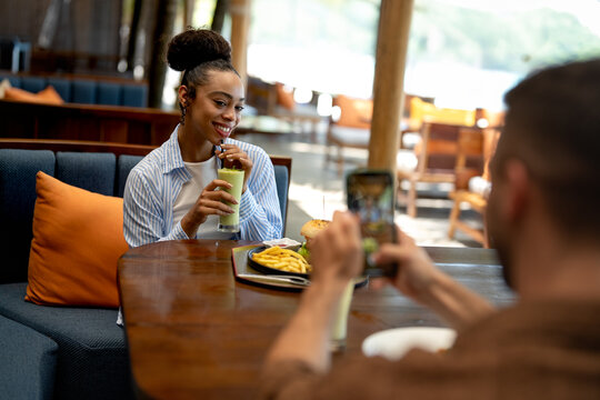 Happy couple shares a moment and a tasty meal at a charming outdoor eatery during their getaway