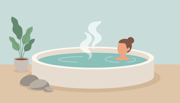 Woman relaxing inside a round indoor hot tub with rising steam next to a potted green plant and grey stones.