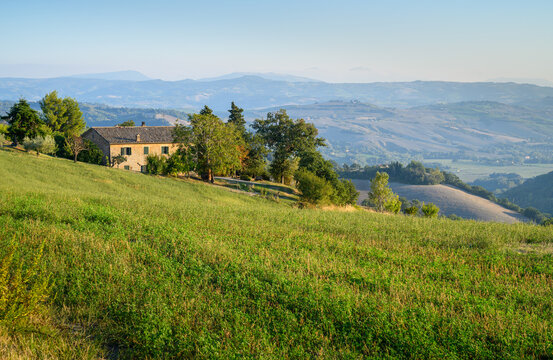 A house on the road between Mondaino and Belvedere Foglience, on the border between Emilia Romagna and Marche, Italy. View of the Montefeltro hills