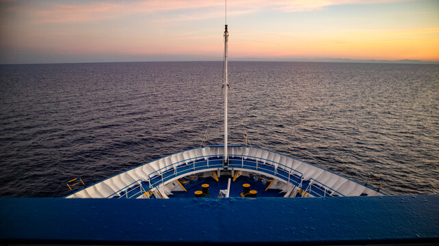 Cruise ship bow sailing across open ocean at sunset maritime travel