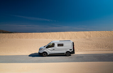 White camper van on road near sand dunes Tarifa Spain © Paolo Corazza