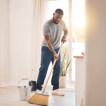 Man mopping floor with modern vacuum cleaner