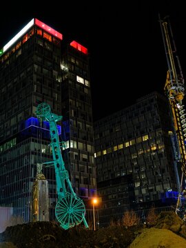 Construction of the Piața Presei Libere metro station featuring tunnel drilling at night in Bucharest with modern buildings in the background