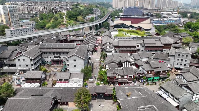 Aerial view of traditional Chinese town with monorail and modern city skyline in Chongqing, China