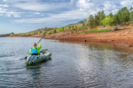 senior male is paddling an inflatable packraft on Horsetooth Reservoir in Colorado
