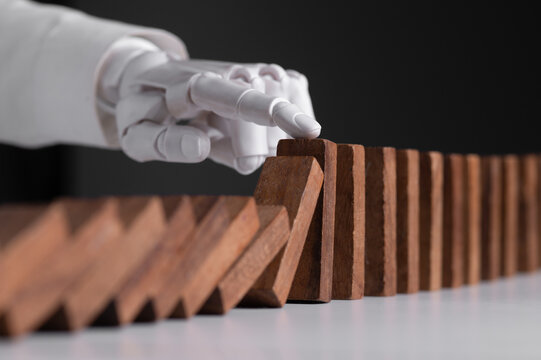 Robotic Hand Stopping Domino Collapse for AI Risk Management and Business Safety