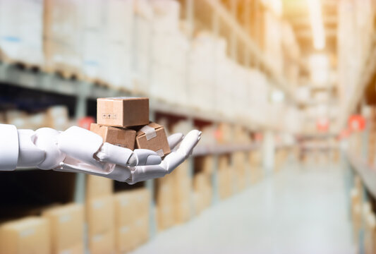 Robotic Hand Holding Cardboard Boxes in Warehouse for Automated Logistics Concept