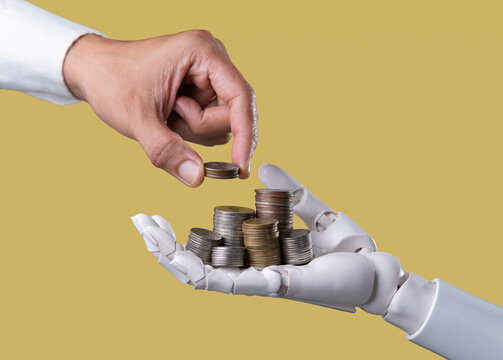 Human and AI Robot Hand Sharing Money Coins on Gold Yellow Background Concept
