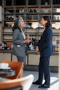 Two business people in suits having a conversation