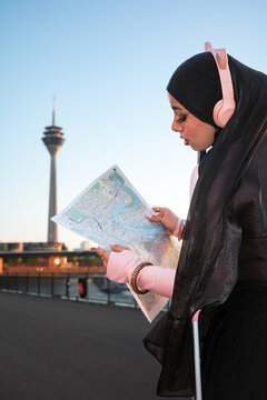 Woman reading city map at Dusseldorf Germany