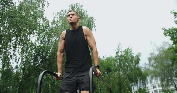 Athletic man has workout, hanging and pull up on parallel bars outdoors. Working out for good health. Fitness and sport lifestyle. Sports, health care, fitness routine, workout. Strength, Outdoors gym