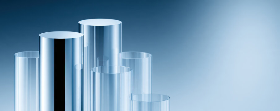 Transparent glass cylinder tubes with reflective surfaces arranged in varying heights on blue gradient background, creating modern and clean look