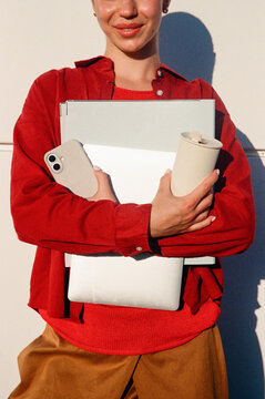 Woman carrying creative work essentials in sunny film photo