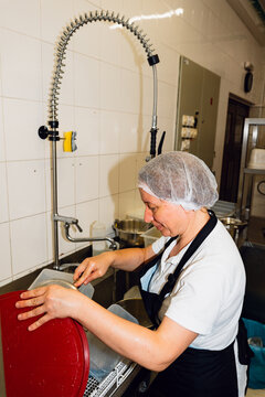 Washing dishes in kitchen