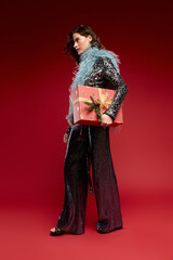 Obraz premium Brilliant holiday glam with a beautiful woman and sparkling accessories