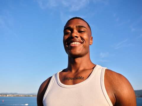 Smiling young man expressing joy and positivity outdoors