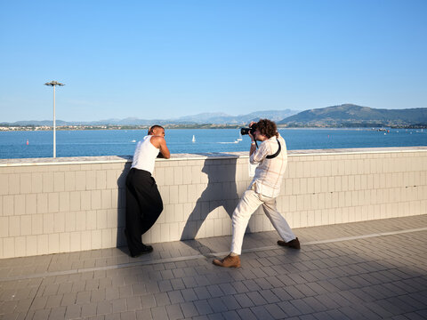 Photographer capturing outdoor portrait of male model
