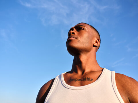 Young black man looking up with determination