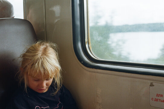 Girl on a Train Looking out at the Scenery During a Journey