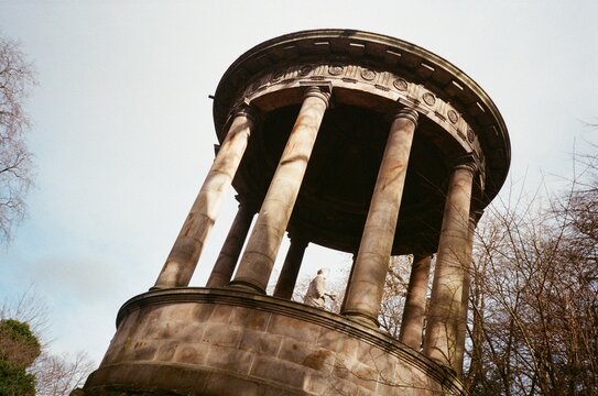 Historic Stone Structure With Columns and a Statue in the Center