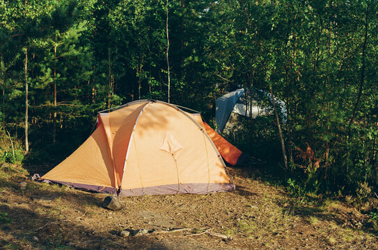 Camping Tent in a Wooded Area Near a Lake