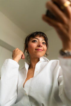 Young Egyptian Woman Putting The Finishing Touches on Her Makeup