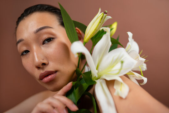 Asian Woman Holding a Lily Flower