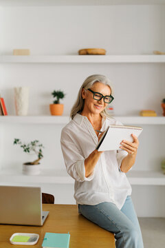 Woman taking notes, working on new ideas in a workspace